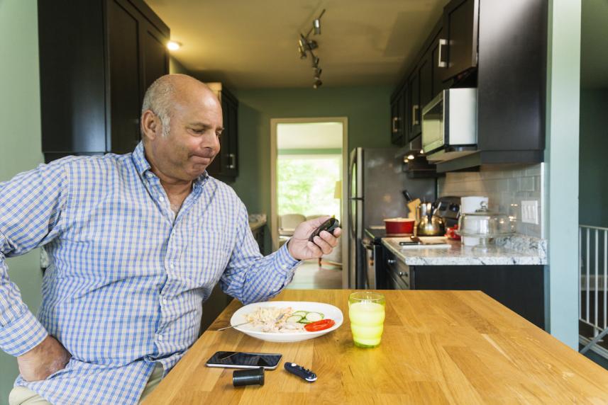 man stressed out looking at his blood sugar meter