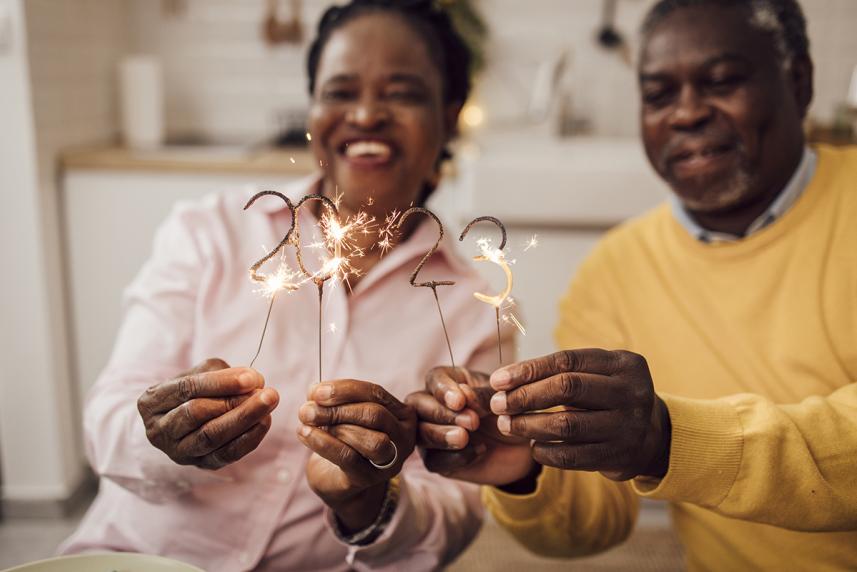 People holding up birthday candles