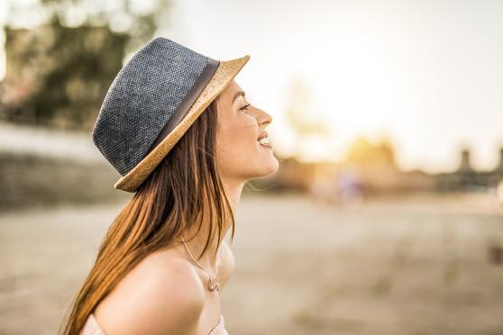 Woman in hat daydreaming