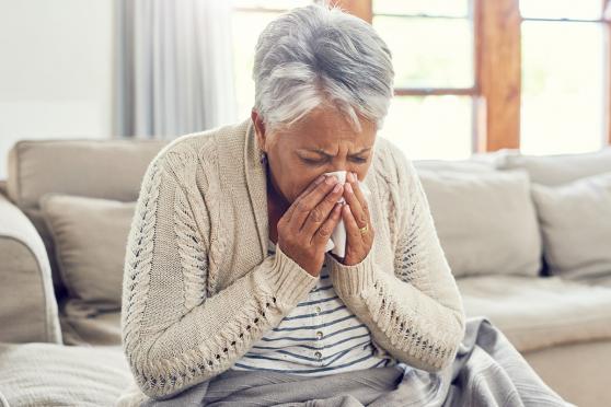 Women blowing her nose into a tissue